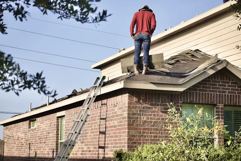 Professional roofer working on a residential roof in Northville